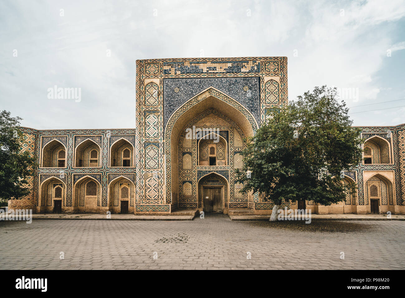 Abandoned Madrasa with tree in Bukhara Uzbekistan Stock Photo