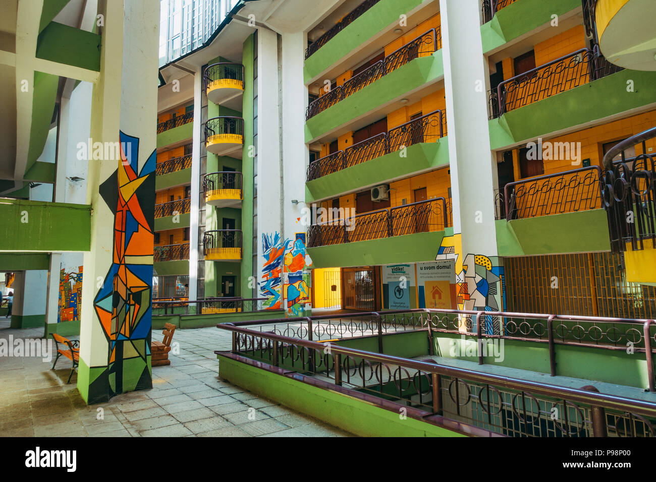 The Papagajka (Parrot) building in Sarajevo, with shades of the brutalist architecture of socialist Yugoslavia, now painted bright yellow and green. Stock Photo