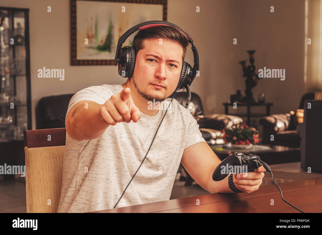 Gamer man pointing finger like it is challenging the spectator to play ...