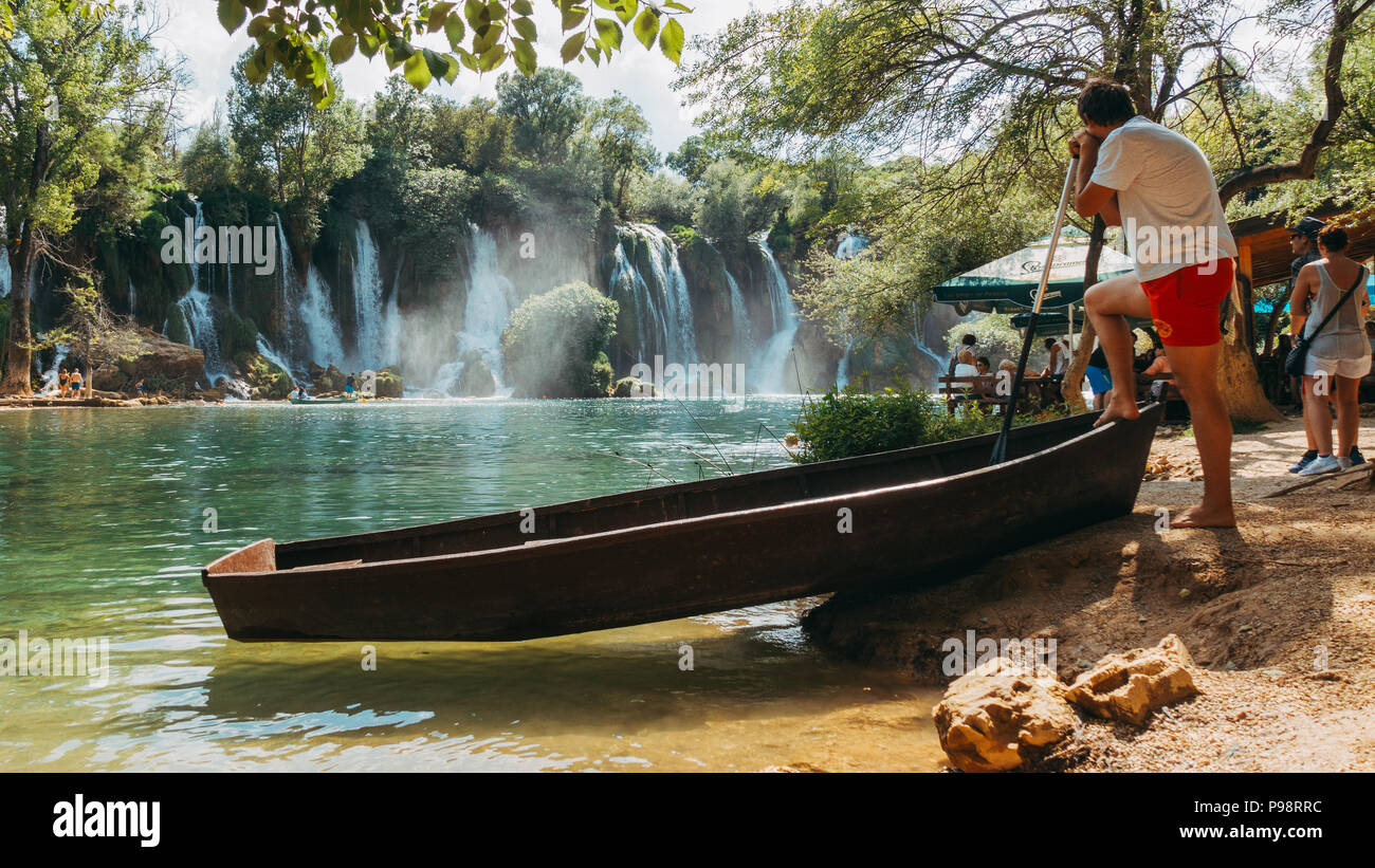 a lifeguard watches over the Kravica waterfall lake - a tufa cascade in Bosnia and Herzegovina, during the busy summer Stock Photo