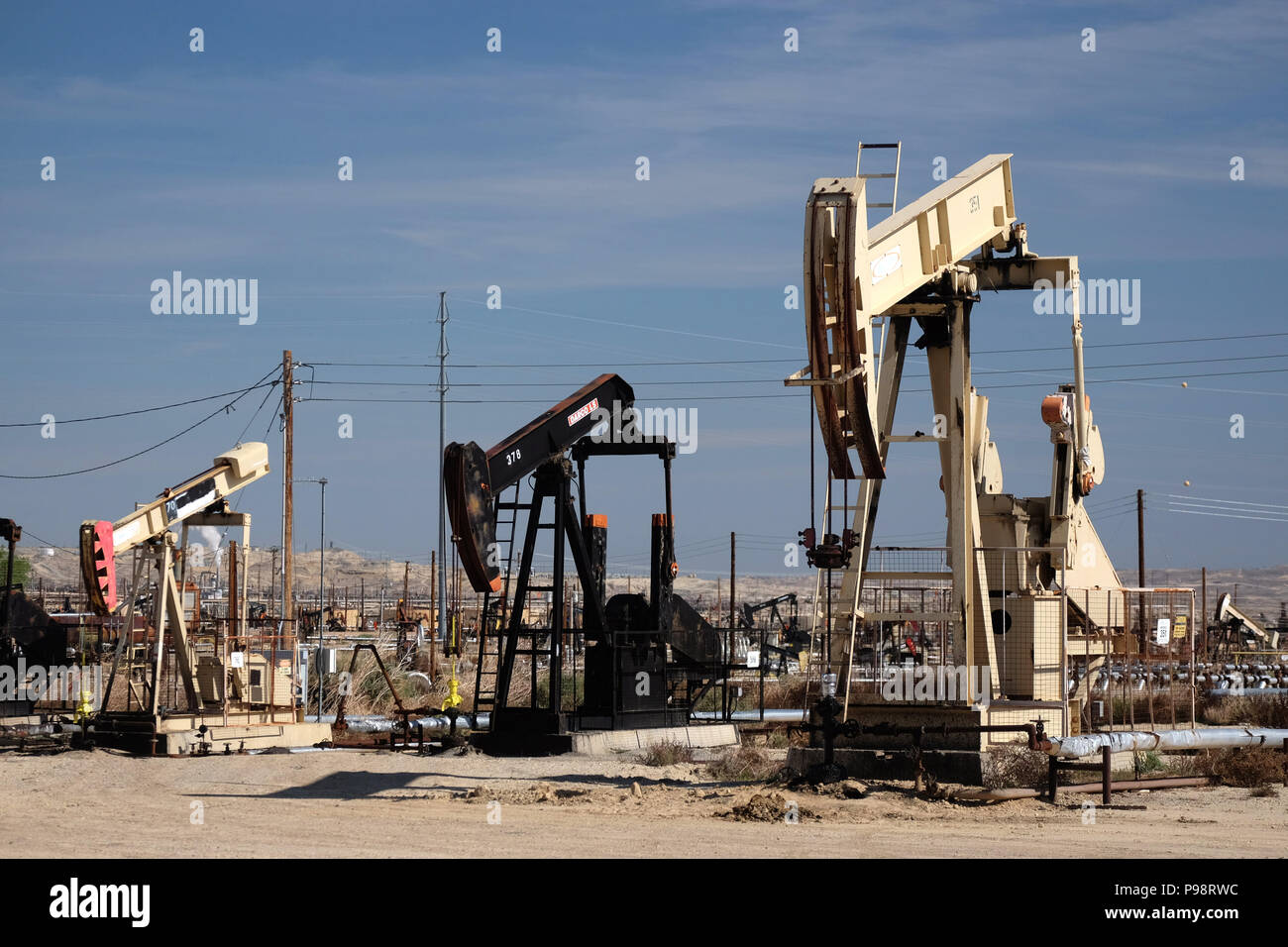 Busy pumpjacks at work in the Sunset-Midway oil field in kern county california Stock Photo