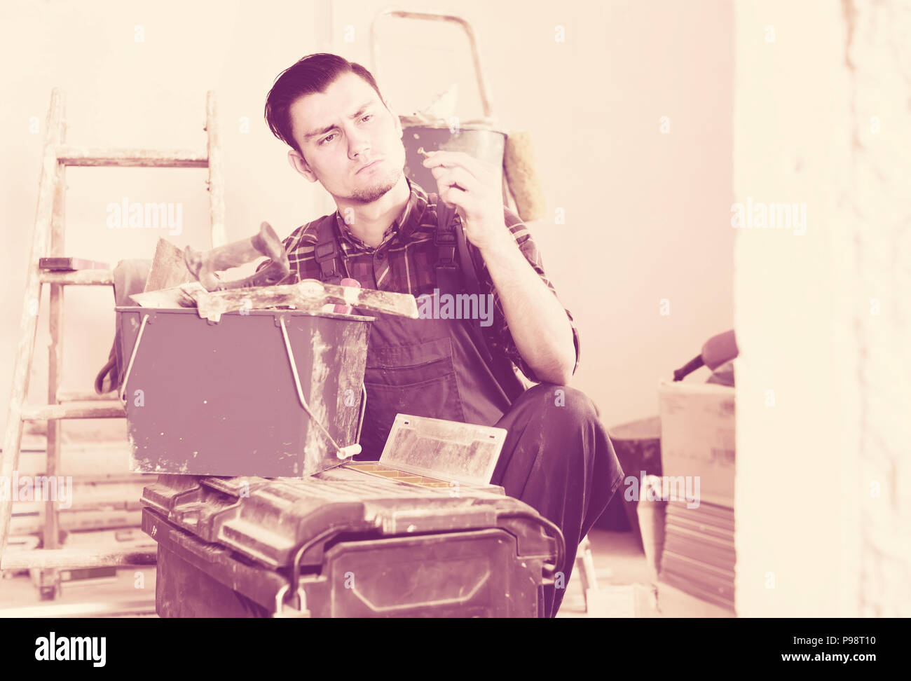 working builder handyman choosing necessary tool in toolbox Stock Photo