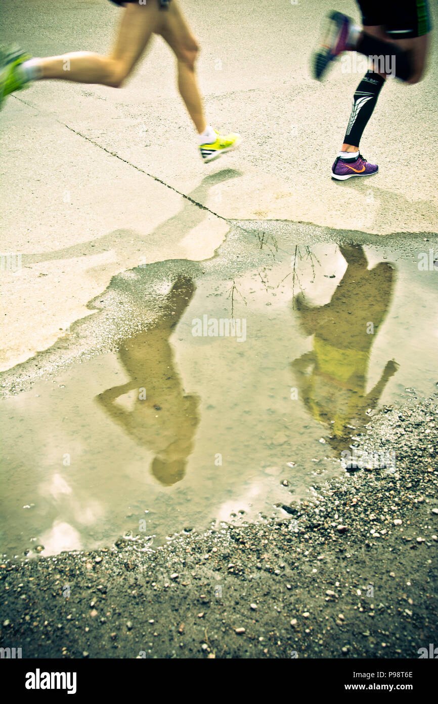 Marathon Runners Legs And Reflection In A Pool Of Water Stock Photo Alamy