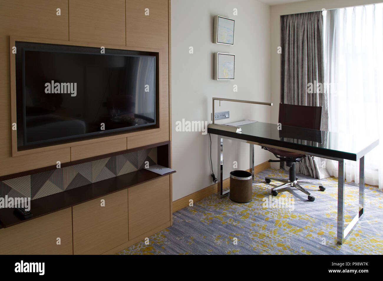 Television and desk in a bedroom at the Cinnamon Grand Hotel in Colombo, Sri Lanka. The luxury hotel is near the Fort area. Stock Photo