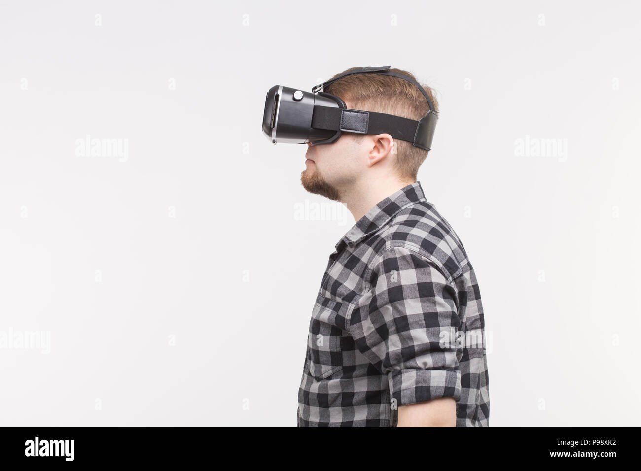 Side view of white men wearing vr glasses Stock Photo