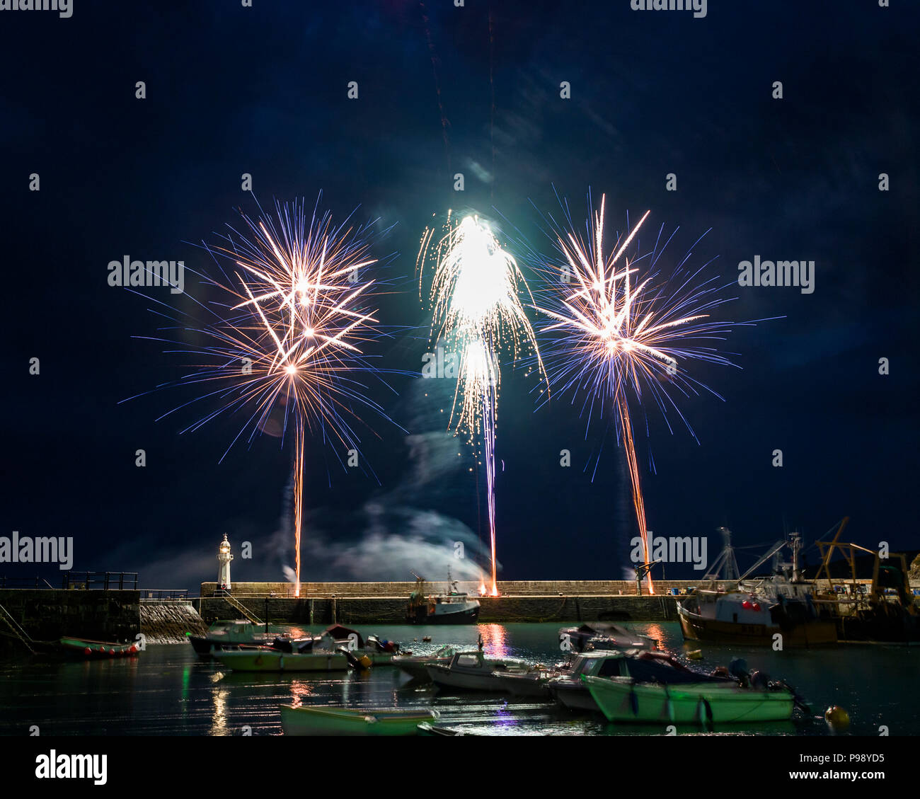 As the 264 year old Mevagissey tradition of holding a festival of food comes to an end a spectacular firework display bathes the harbour in colour. Stock Photo