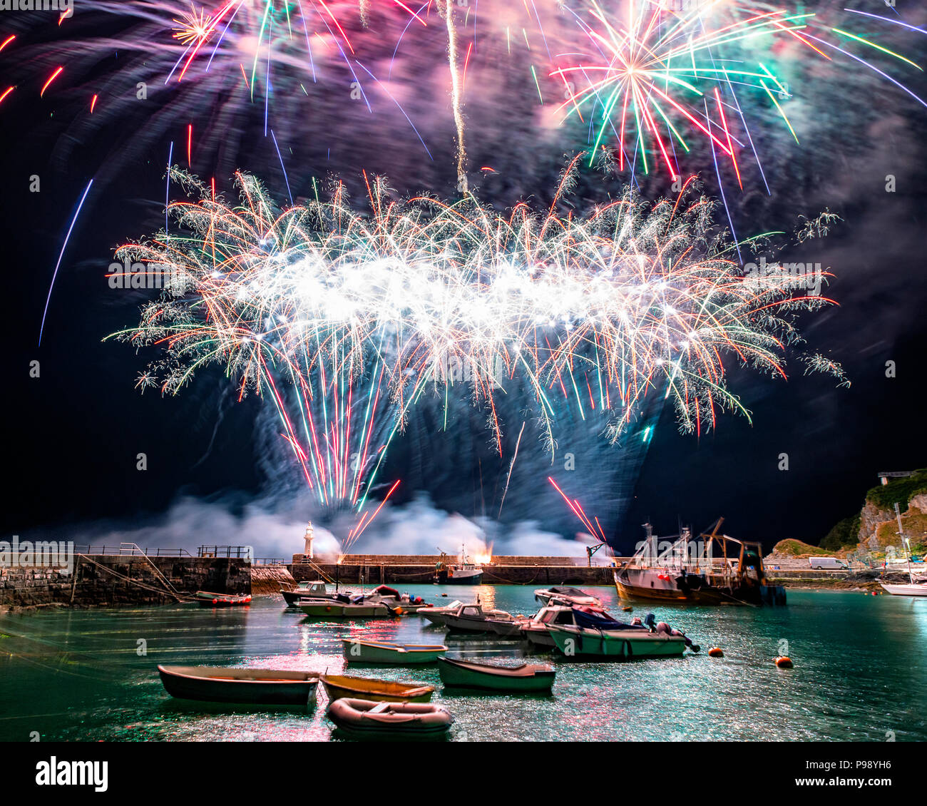 As the 264 year old Mevagissey tradition of holding a festival of food comes to an end a spectacular firework display bathes the harbour in colour. Stock Photo