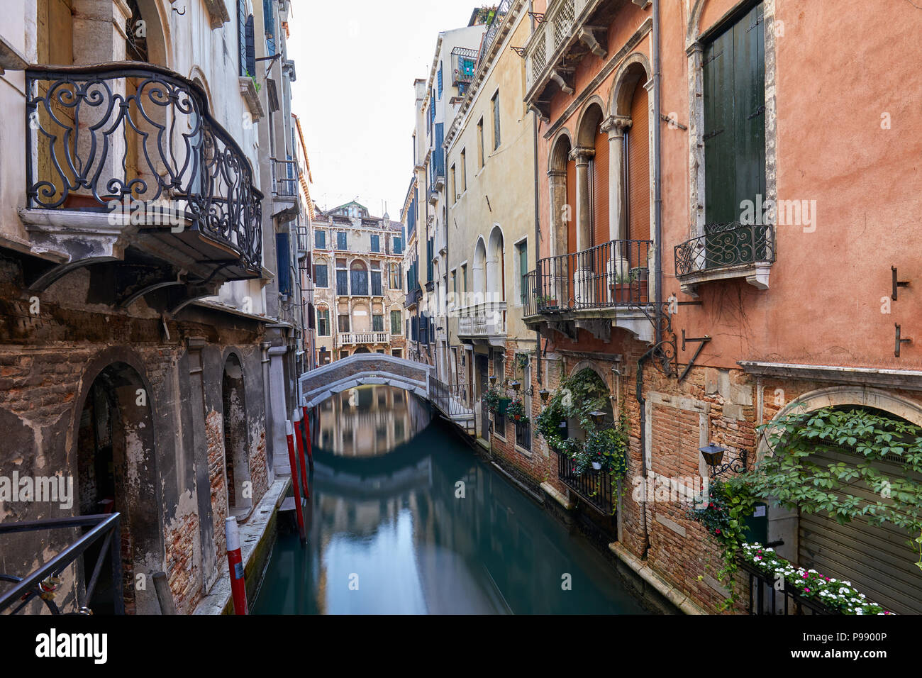 Venice canal with ancient buildings and houses facades in Italy Stock Photo