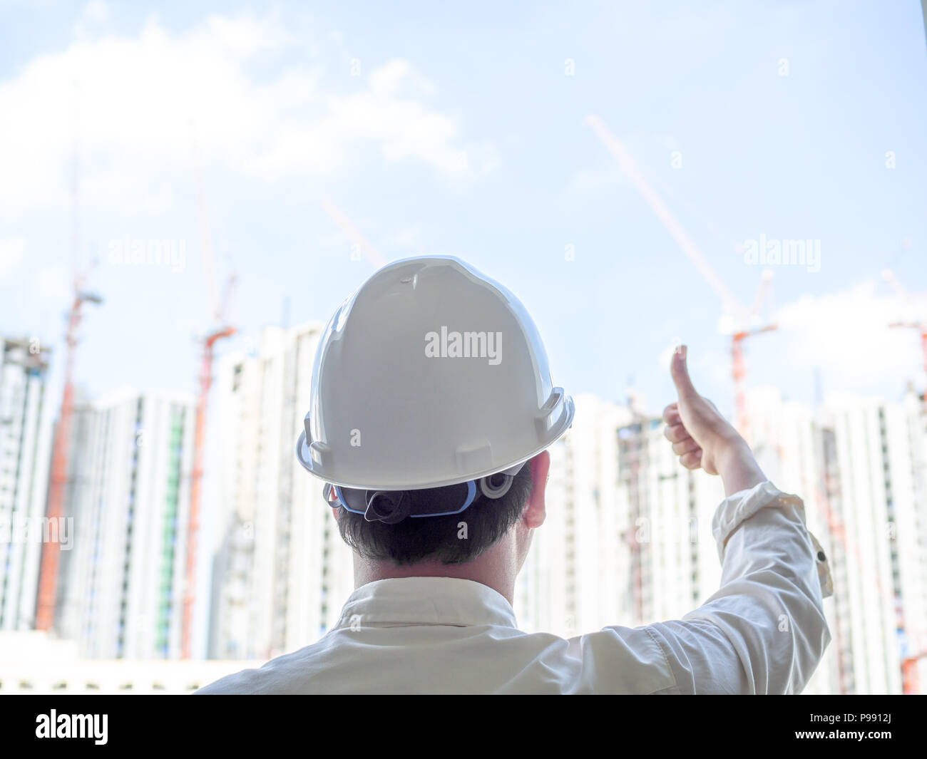 Engineer man back view wearing white hard safety helmet and white shirt ...