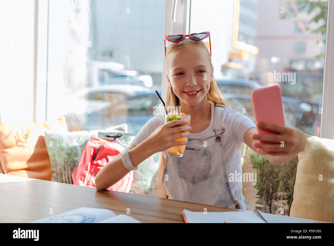 Modern teenager smiling while making selfie Stock Photo