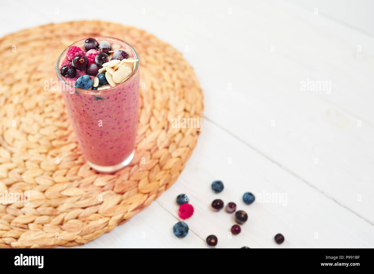 Glass of pink fruit smoothies milkshake or cocktail on white background, breakfast vegan, with a place for your text, concept of raw food Stock Photo