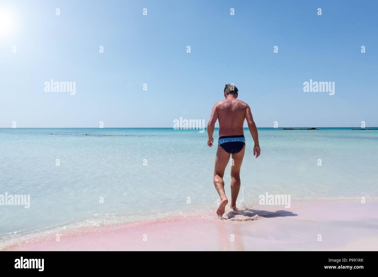 Adult male on the pink sand beach at Elafonisi on the island of Crete Stock Photo
