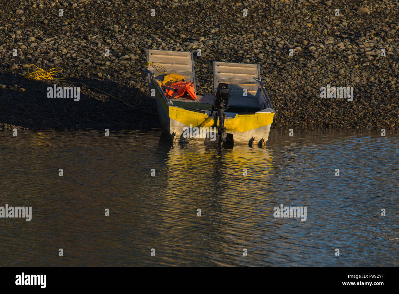 Dingy with the evening glow on the water Stock Photo