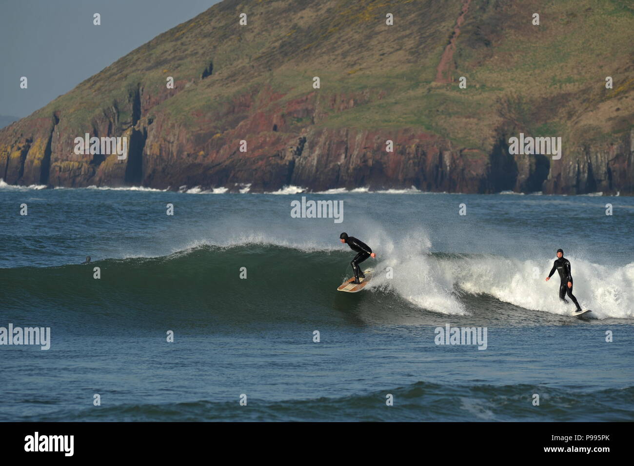 Often Sheltered from the wind  Atlantic waves provide perfect surfing conditions at Manorbier, Pembroke in West Wales Stock Photo