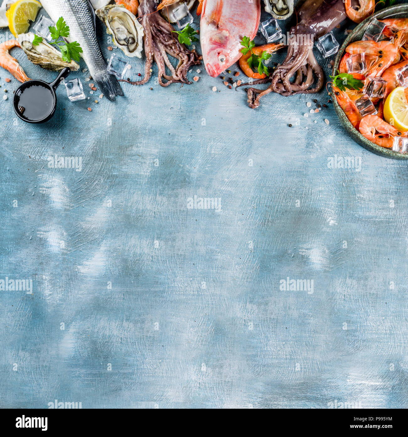 Fresh raw seafood squid shrimp oyster mussels fish with spices of herbs