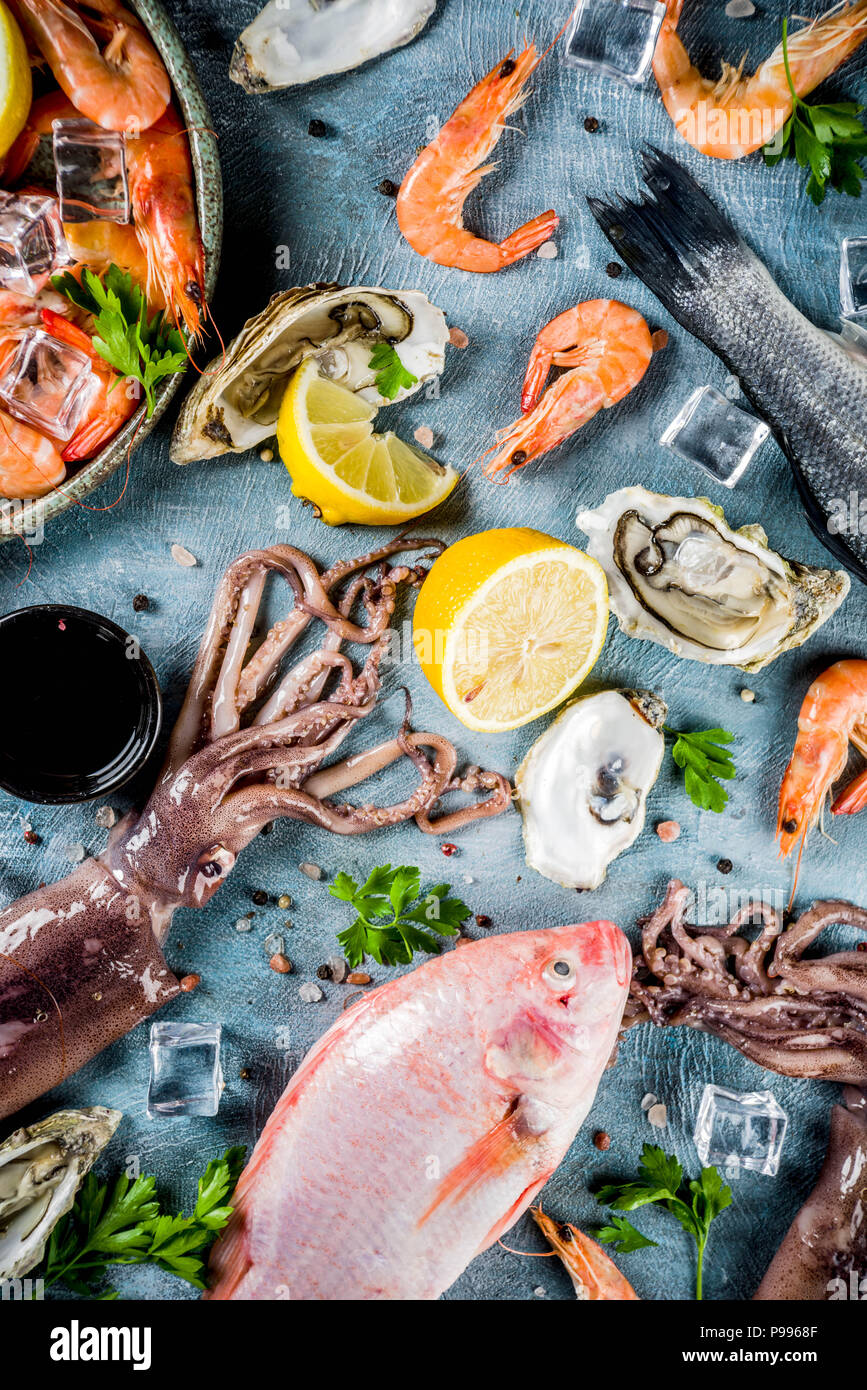 Fresh raw seafood squid shrimp oyster mussels fish with spices of herbs