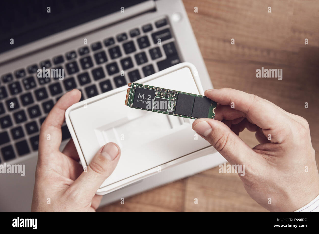 Man unpacks the newly purchased M.2 SSD drive over his desk with a modern  laptop Stock Photo - Alamy