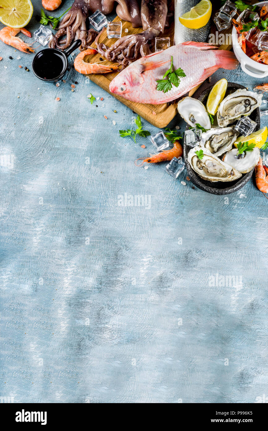 Fresh raw seafood squid shrimp oyster mussels fish with spices of herbs