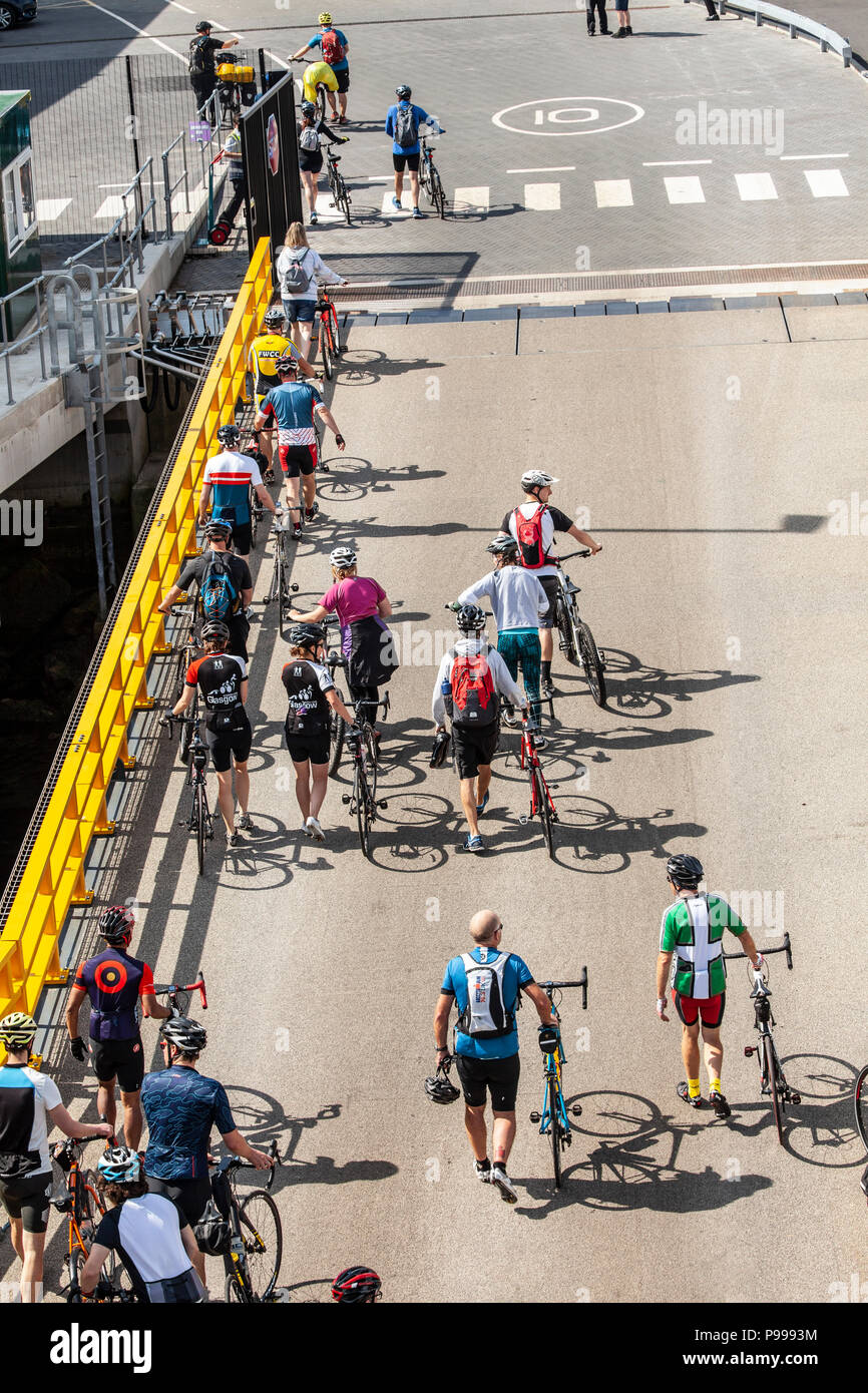 Cyclists disembarking from the Arran Ferry via the car ramp at the new Passenger Terminal at Brodick Pier, Isle of Arran Stock Photo