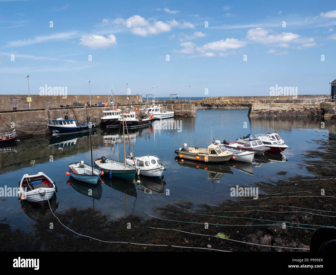 St Abbs harbour village with fishing, scuba diving, sailing - Berwickshire coast, Scotland. Boats and harbour. Stock Photo