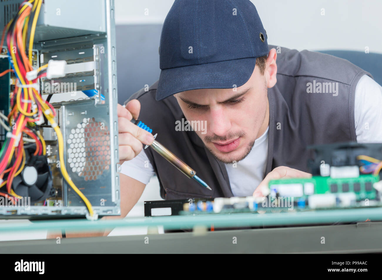 electronic engineer repairing electronic devices on broken computer