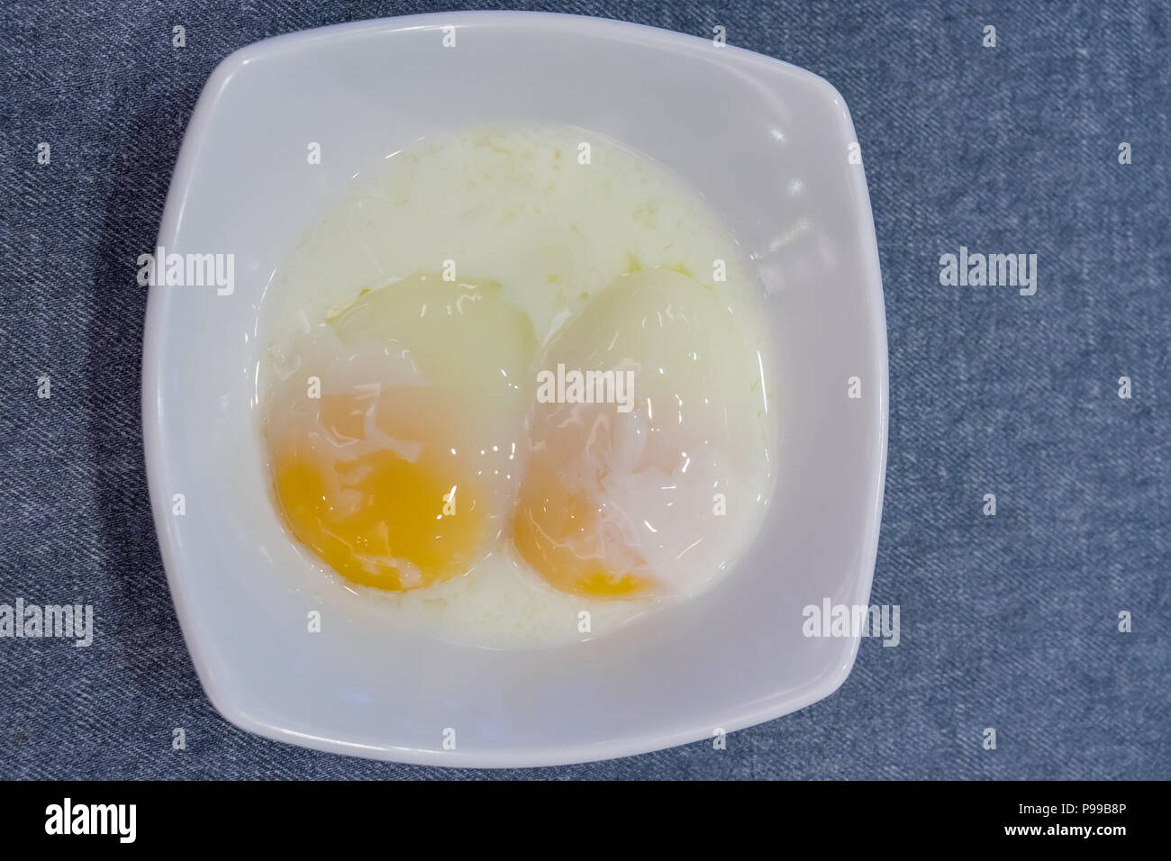 Half boiled eggs traditional Singapore breakfast called Kaya Toast