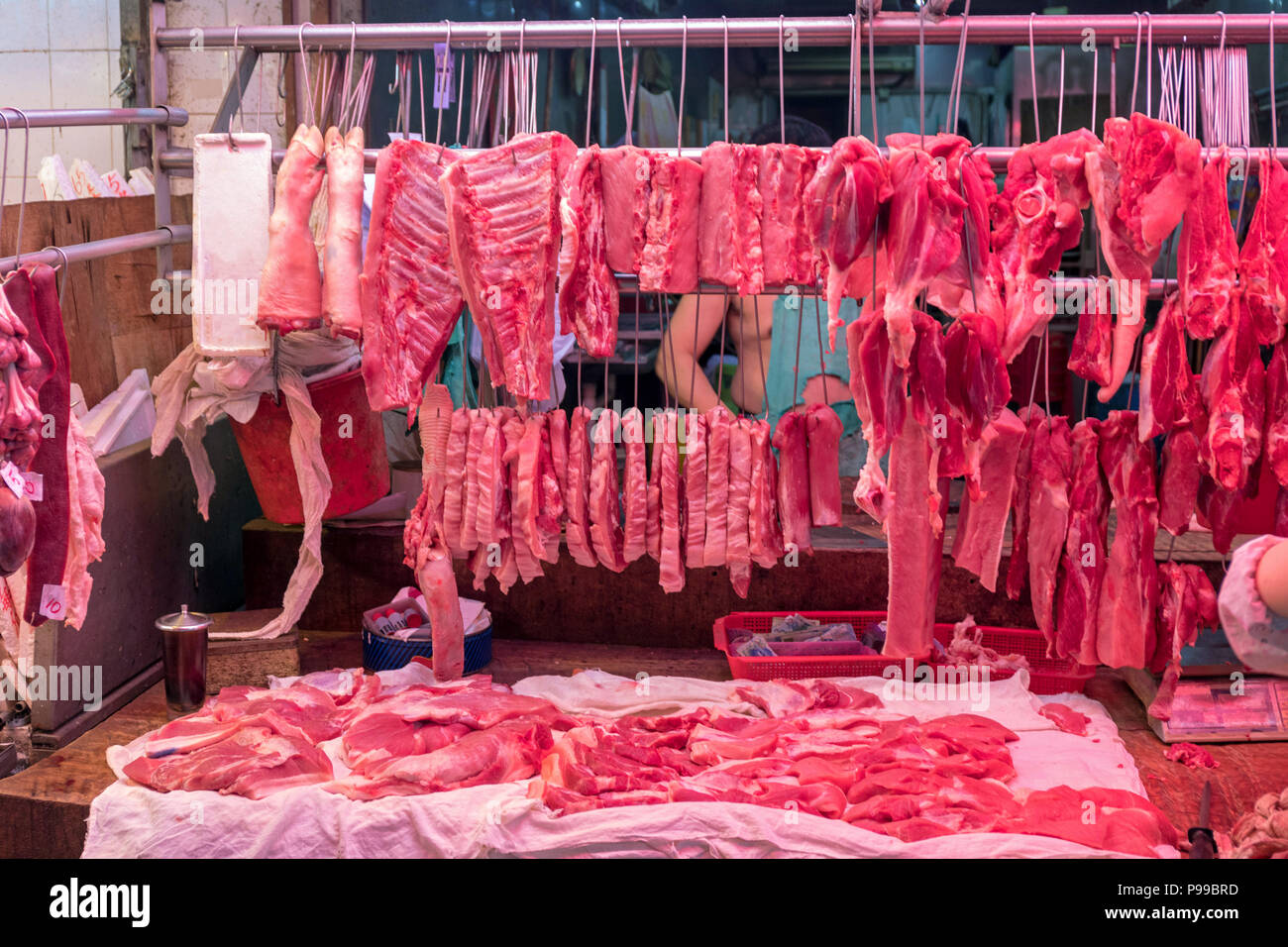 Red Meat Hanging at Butcher Shop in China Stock Photo
