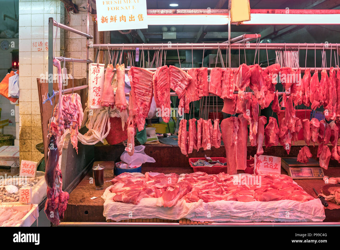 Hanging Fresh Meat Parts at Butcher Shop Stock Photo