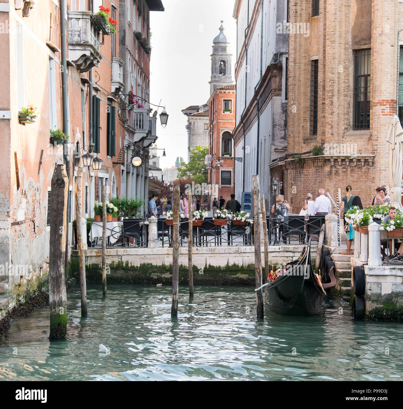 Europe, Italy, Veneto, Venice. People sitting at the restaurant near Ponte del Accademia, Gallerie dell Accademia, at the Grand Canal in Venice. Stock Photo