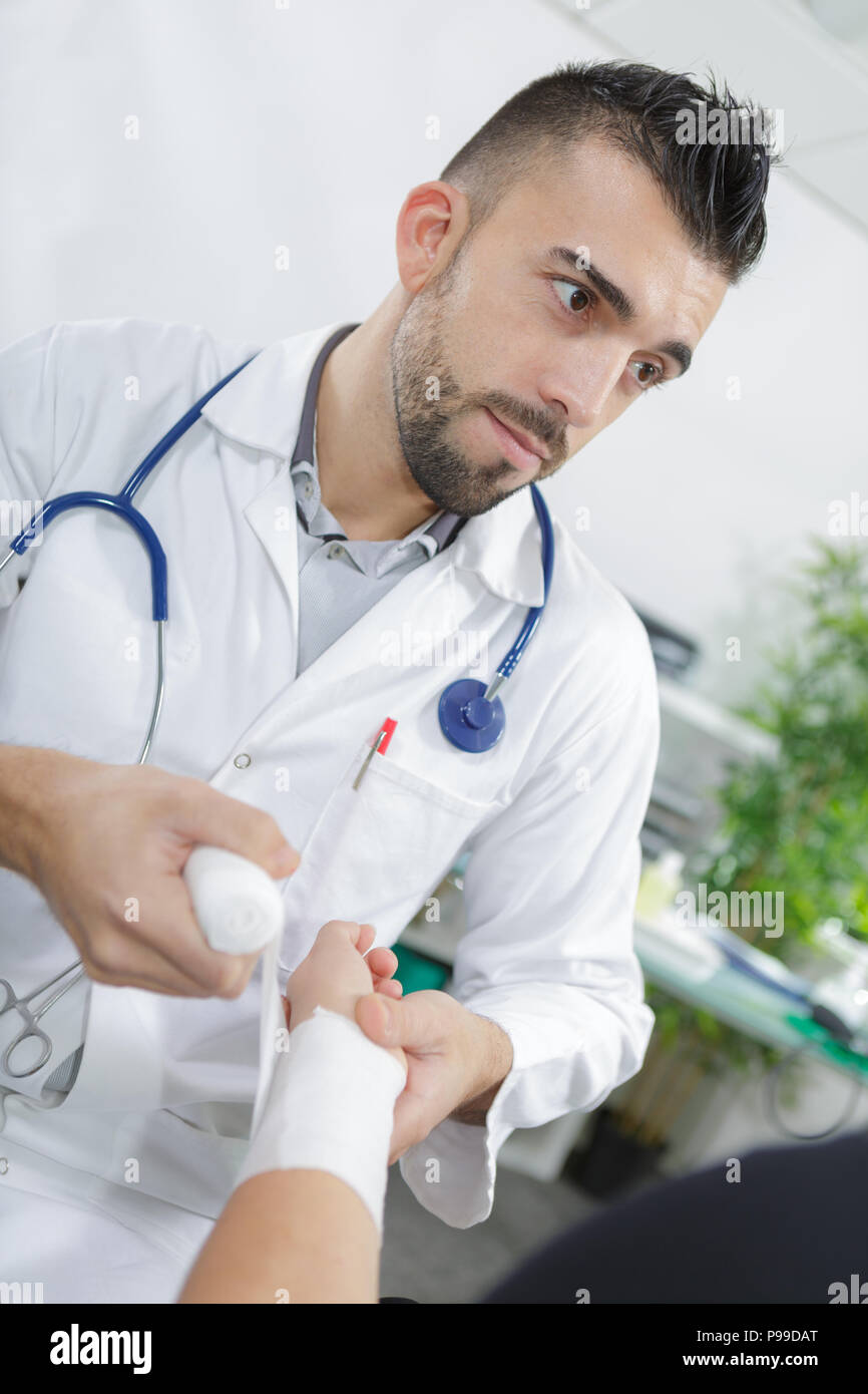 doctor wrapping a wrist with bandage Stock Photo Alamy