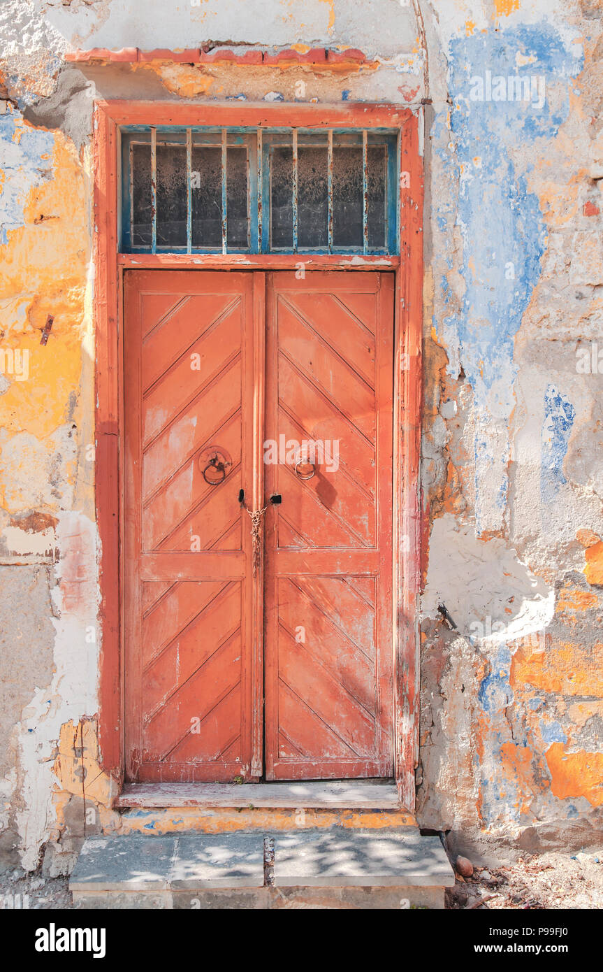 Modern Closed Dark Red Wooden Door On Yellow Cement Textured House