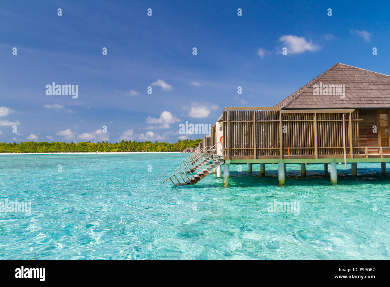 Luxury over water bungalow and villas side view with beautiful blue sea and lagoon Stock Photo