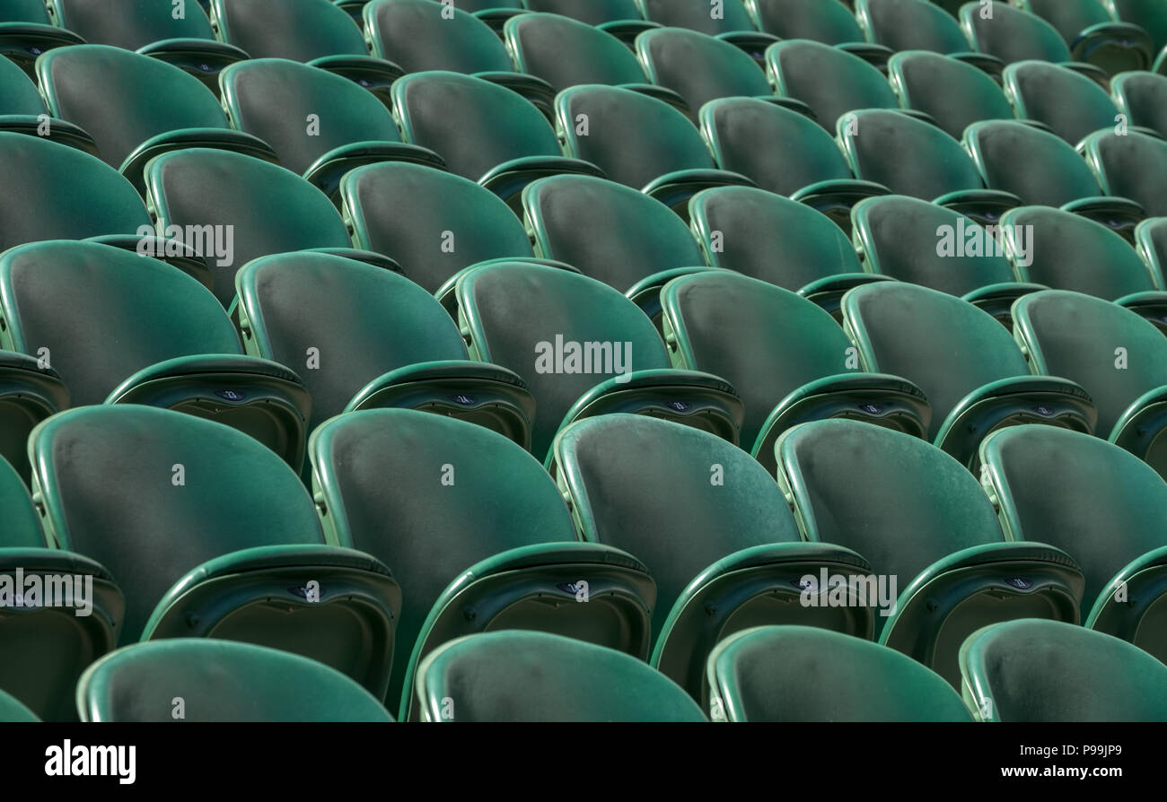 Wimbledon London, July 2018. Rows of empty green spectators' chairs at Wimbledon All England Lawn Tennis Club. Stock Photo