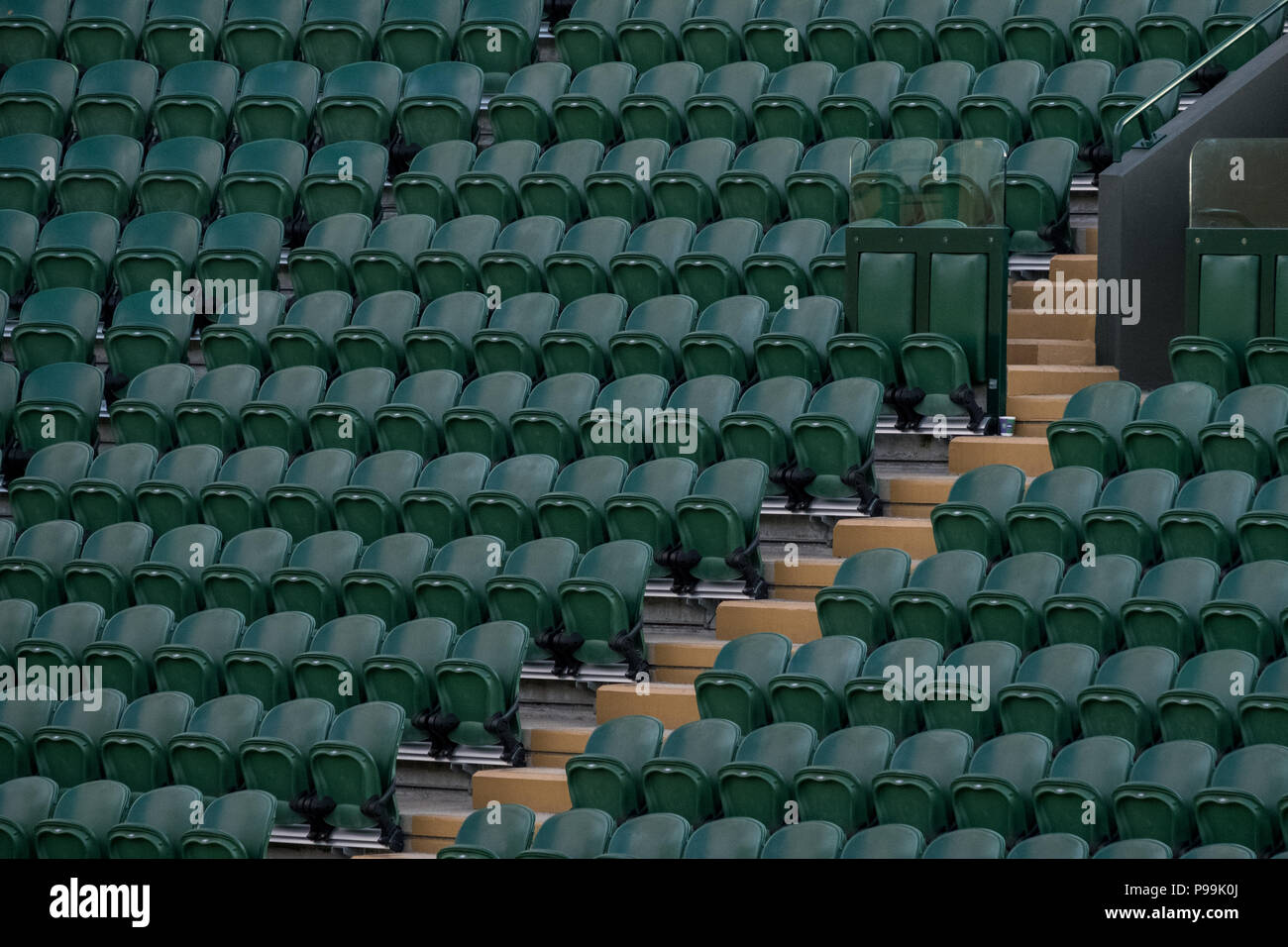 Wimbledon London, July 2018. Rows of empty green spectators' seats at Wimbledon All England Lawn Tennis Club. Stock Photo