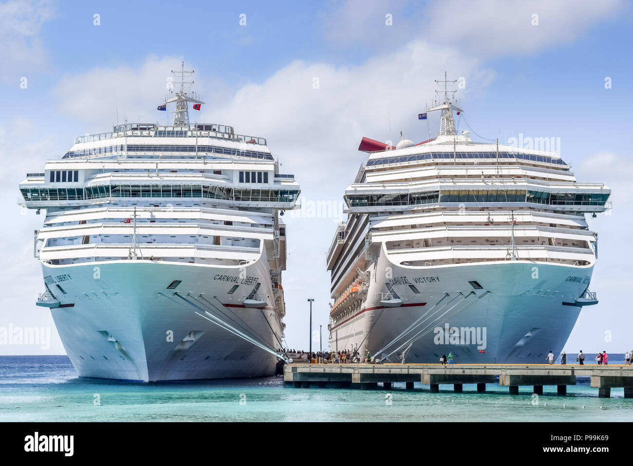 Grand Turk, Turks and Caicos Islands - April 03 2014: Carnival Liberty and Carnival Victory Cruise Ships docked side by side in Grand Turk. Stock Photo