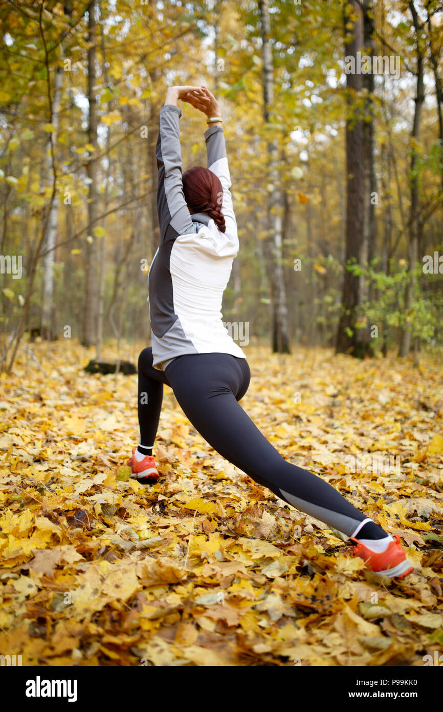 Woman stretching in woods hi-res stock photography and images - Alamy