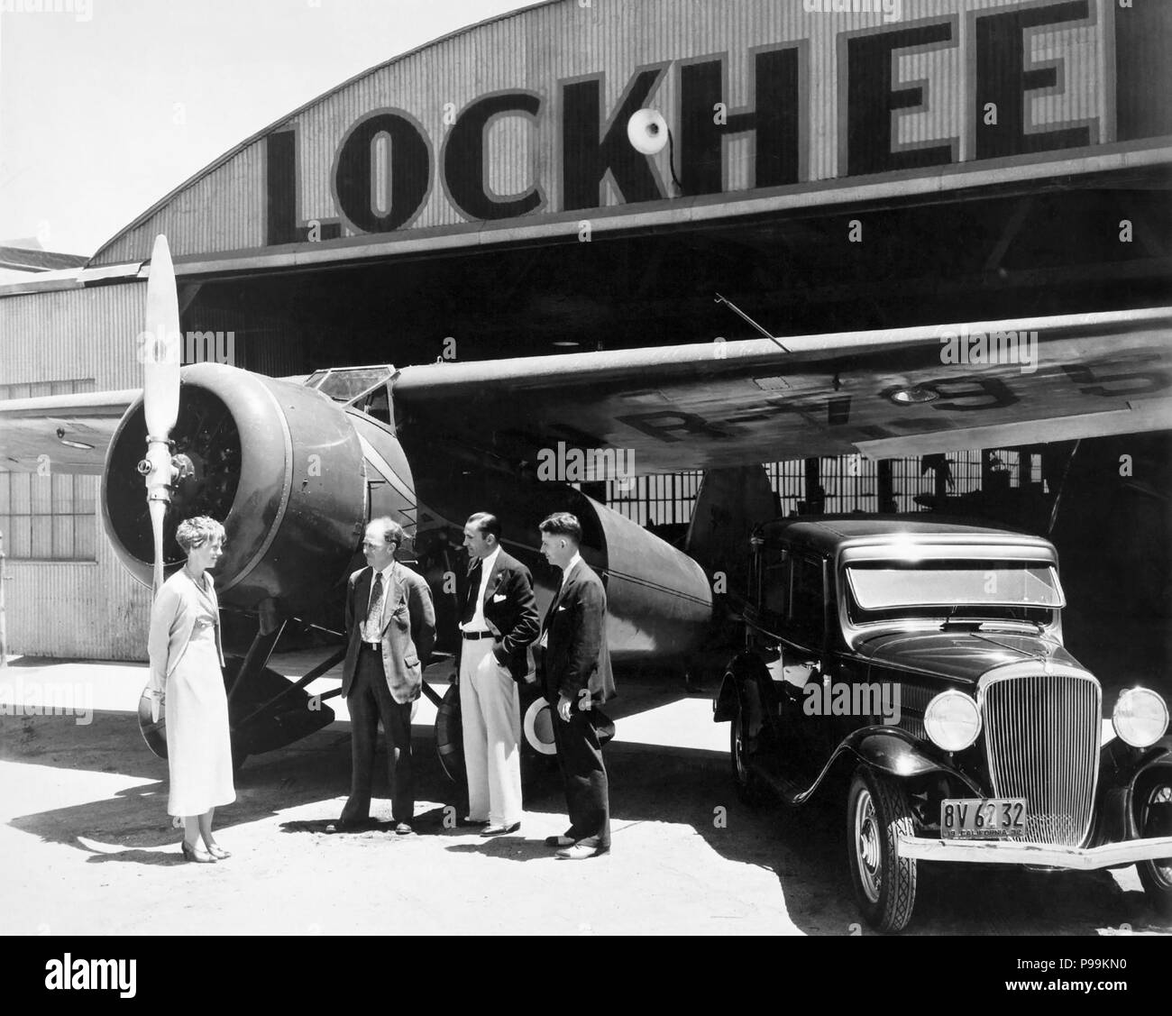 Amelia Earhart with Allen Lockheed, Carl Squier and Floyd Steam at Lockheed's hangar in Burbank, California, standing next to the Lockheed Vega 5B in which Earhart became the first woman to complete a solo transatlantic flight on May 21, 1932. (Photo: 1932) Stock Photo