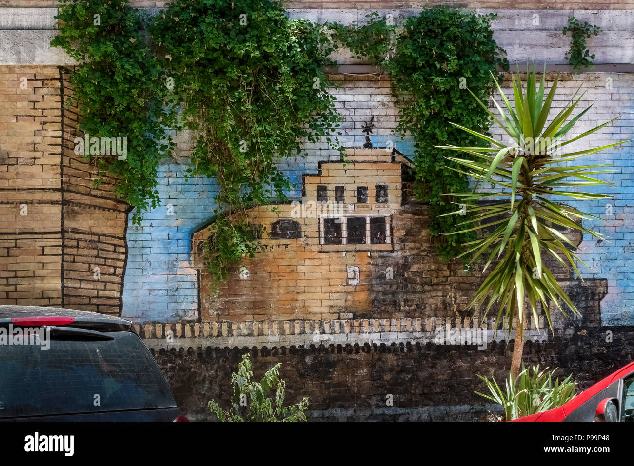 Glimpse of a street graffiti mural depicting Castle of the Holy Angel painted on a brick wall in an alley of Rome, Italy, Europe. Street art, close up Stock Photo