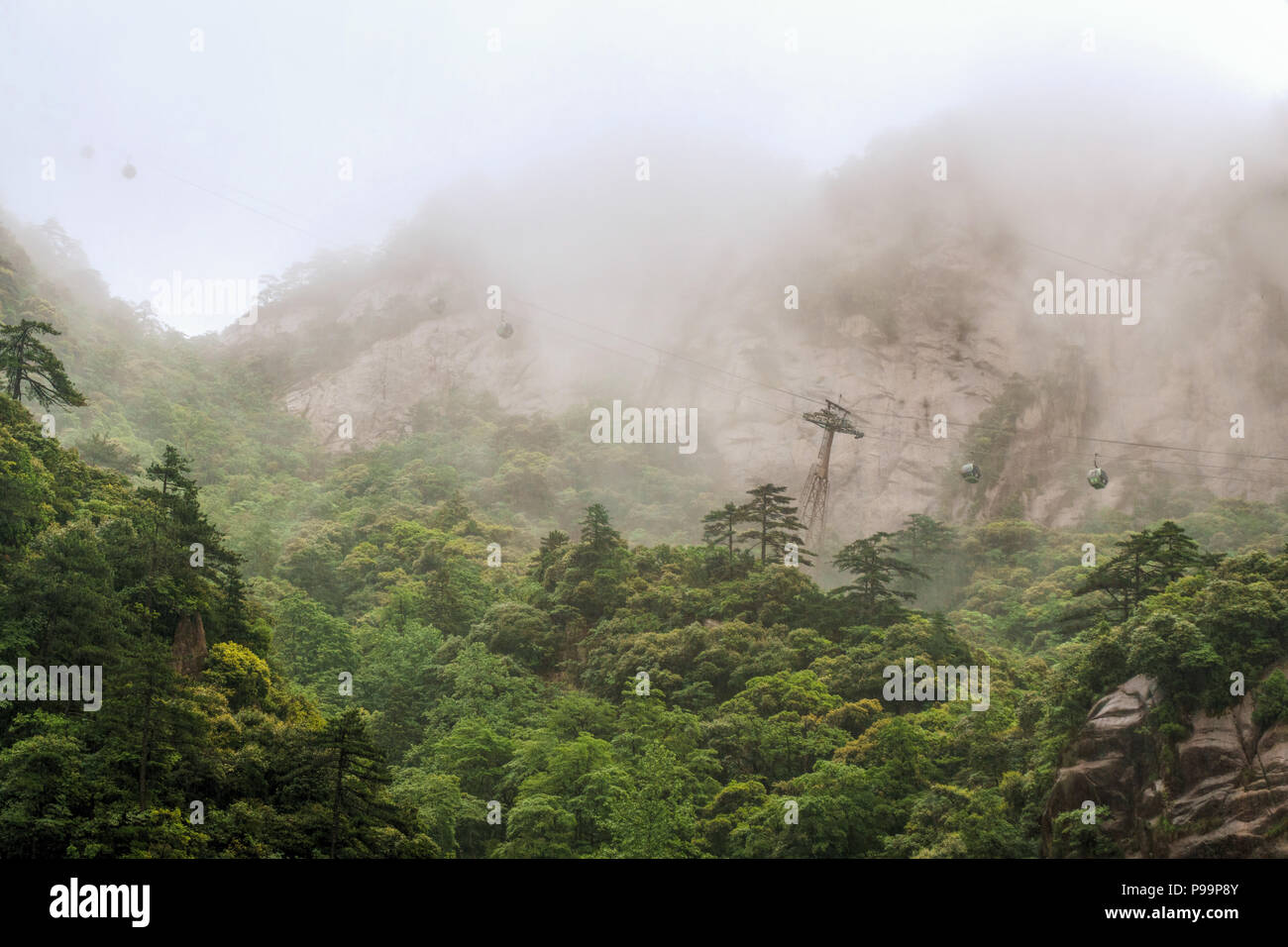 Taiping cable car dissapearing in clouds,  Huangshan (literal meaning: Yellow Mountain) is a mountain range in southern Anhui province, eastern China Stock Photo