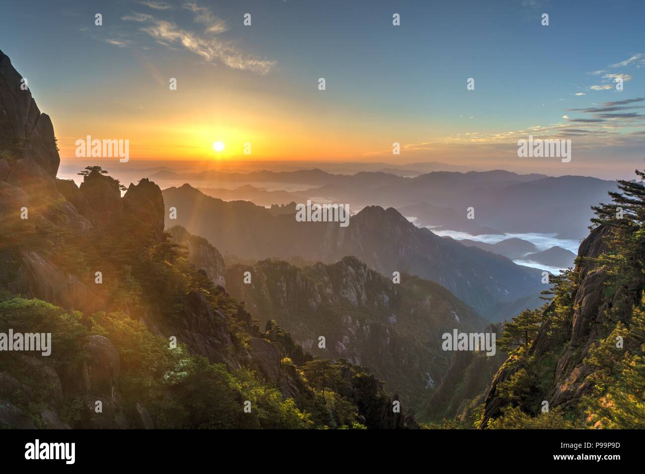 Colourful sunrise over sea of clouds at one of the peaks of Huangshan mountain range in southern Anhui province in eastern China. Stock Photo