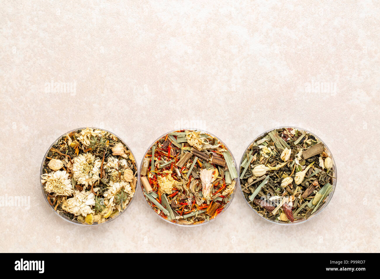 a set of three Chinese herb teas in round bowls against ceramic