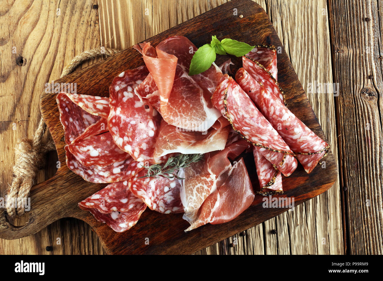 Food tray with delicious salami, raw ham and italian crudo or jamon