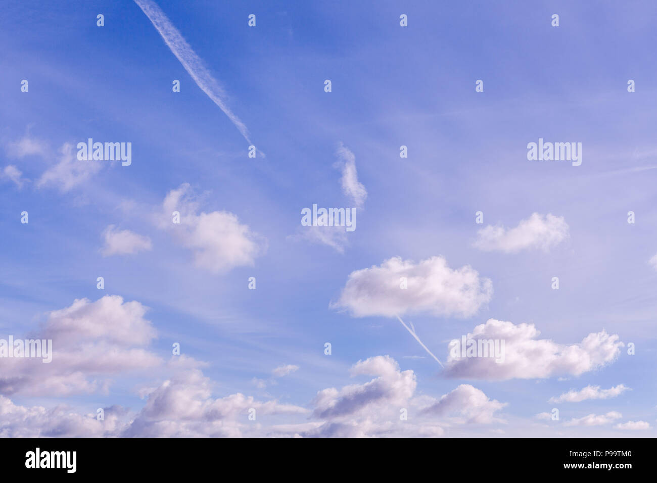 Blue sky and fluffy clouds background Stock Photo - Alamy