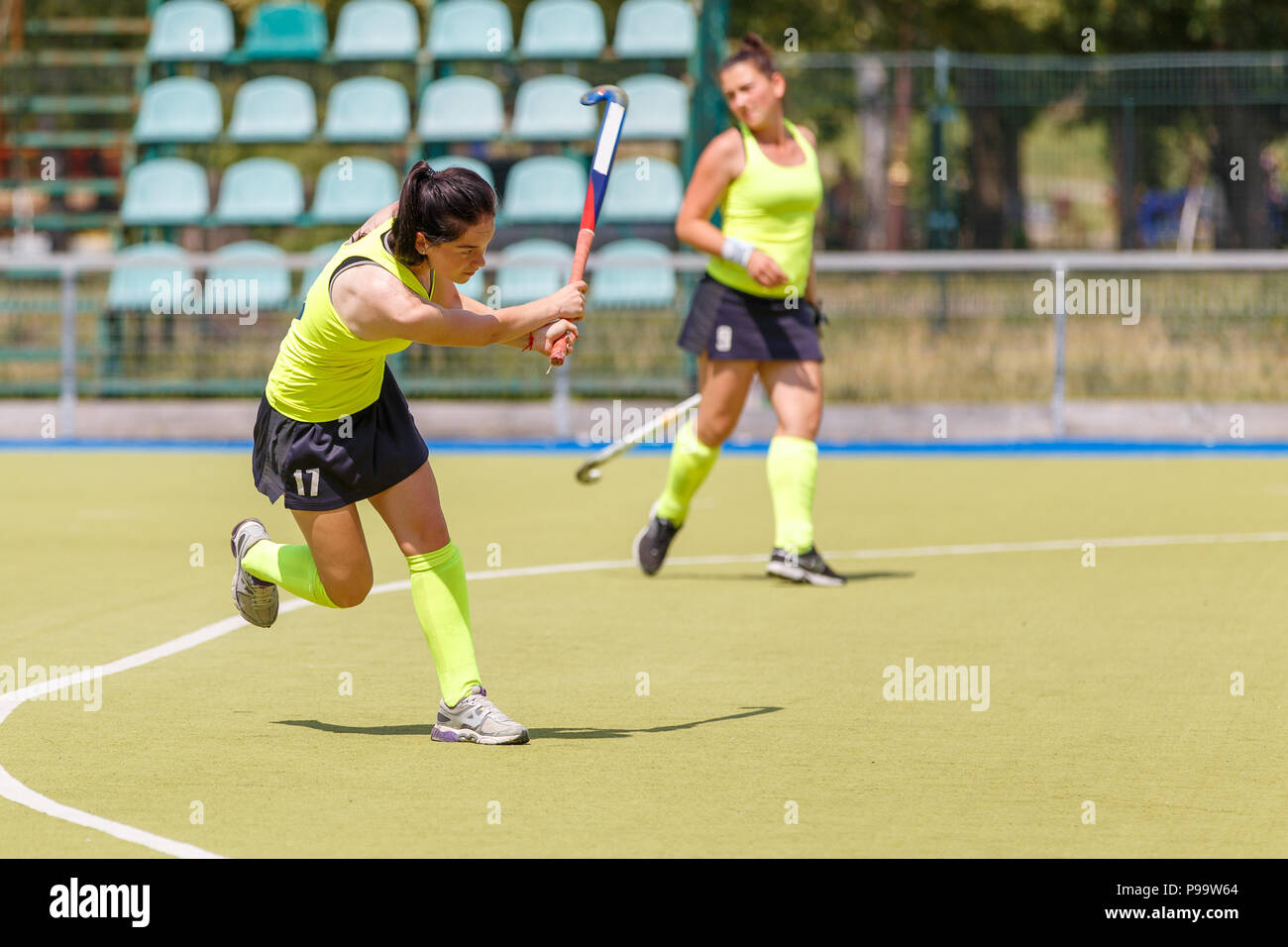 Young hockey player hit ball in field hockey game Stock Photo Alamy