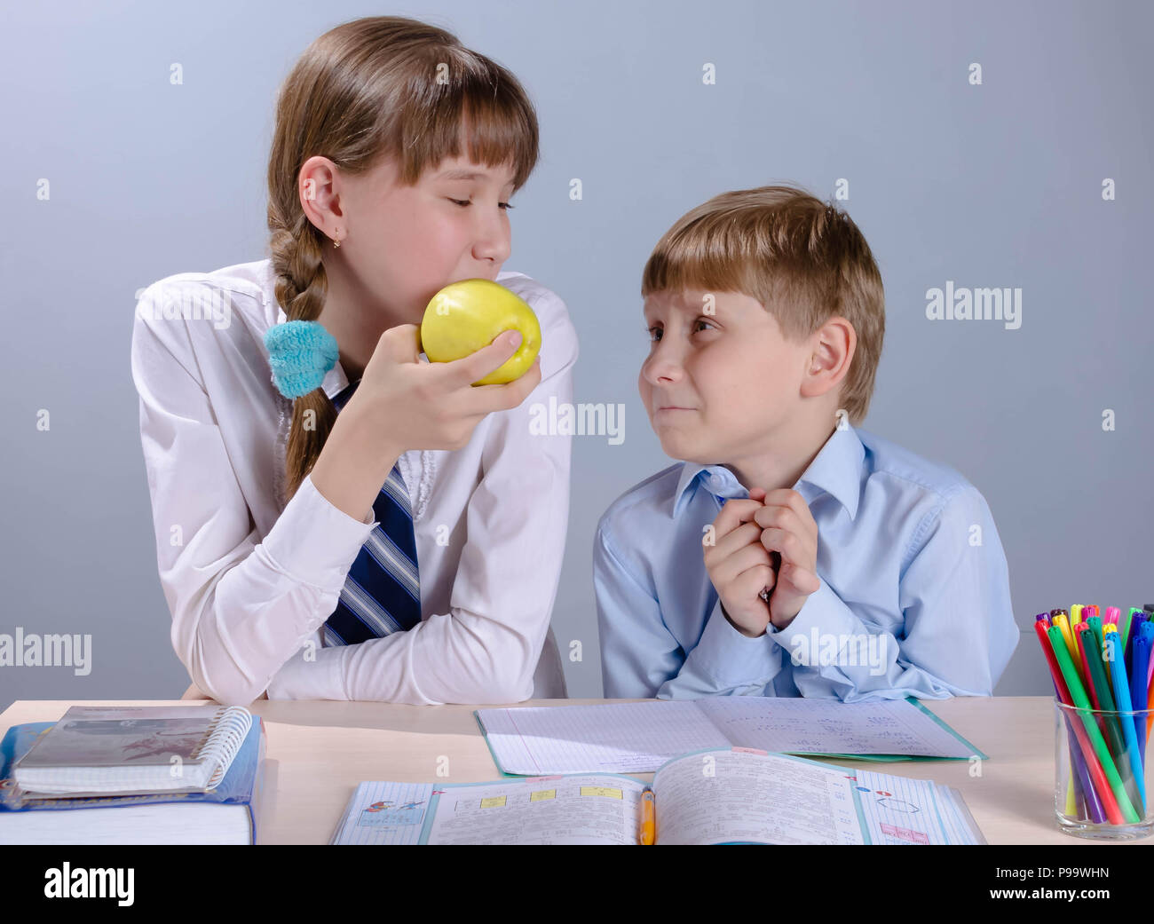 schoolchild boy and girl at a desk in the classroom Stock Photo