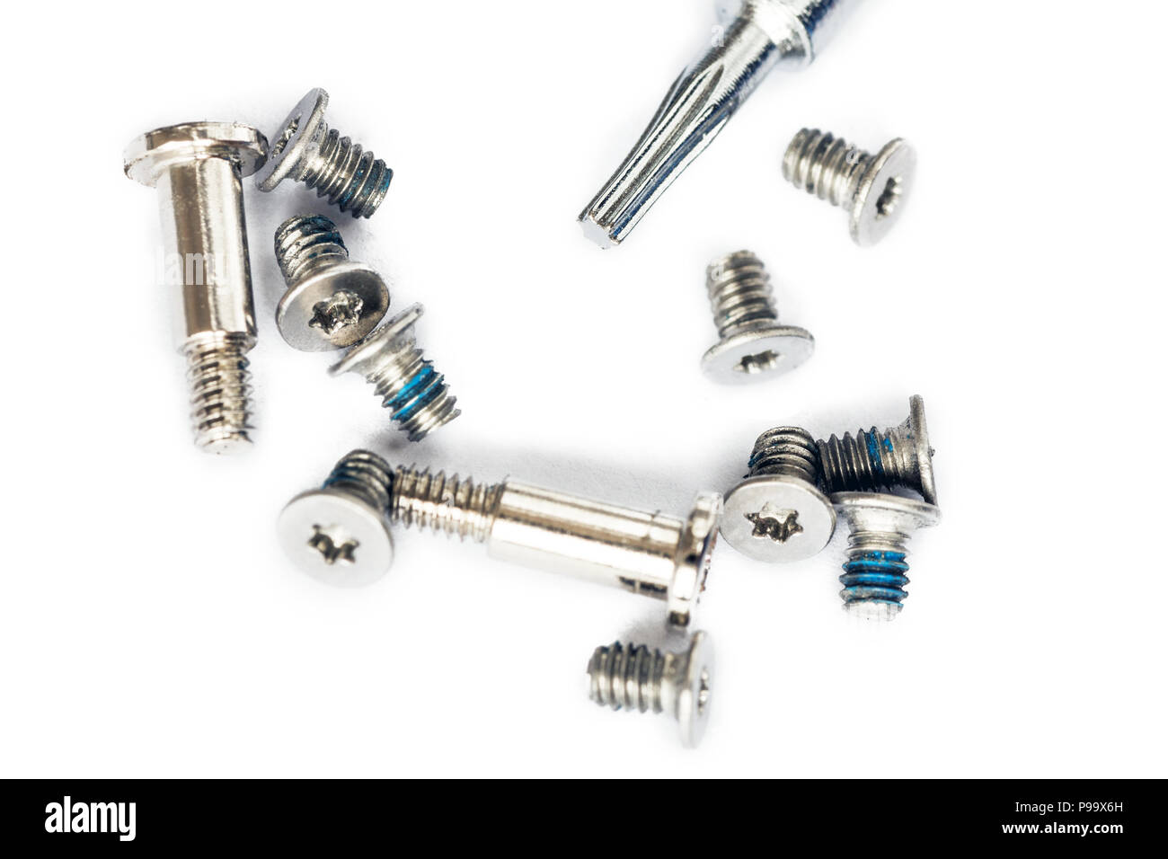 Small laptop screws and screwdriver isoltaed on white background