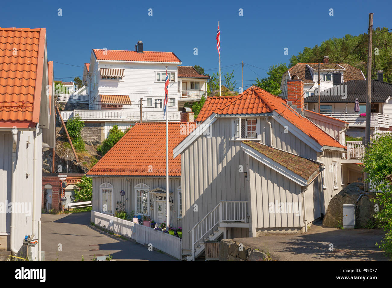 Typical white houses in Kragero, built against the mountain side Stock Photo