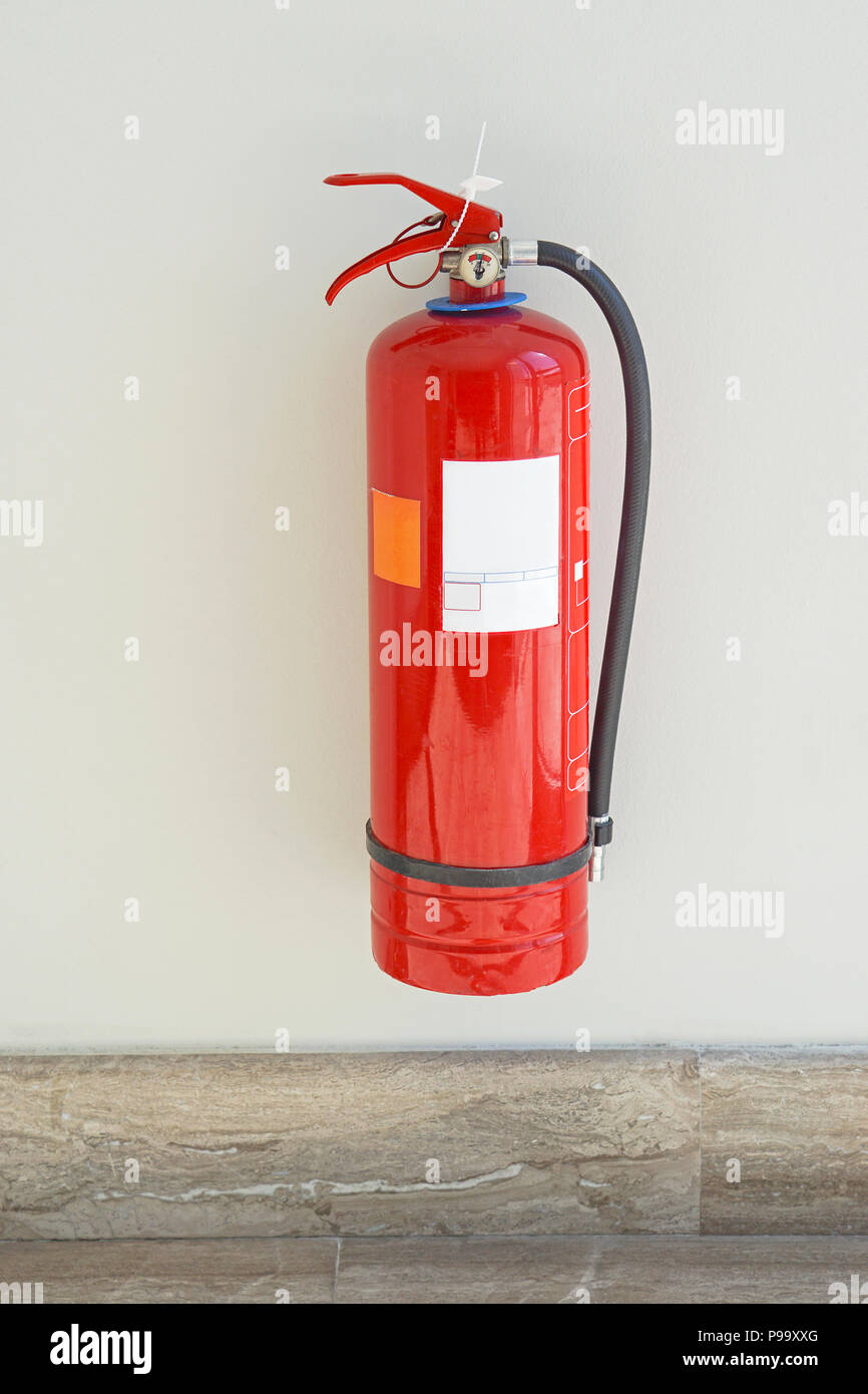Fire extinguisher protectuion device at wall Stock Photo Alamy