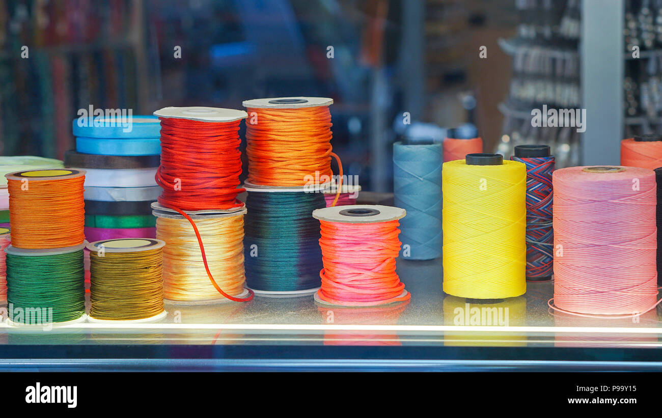 Colorful sewing threads and yarns at spools Stock Photo - Alamy