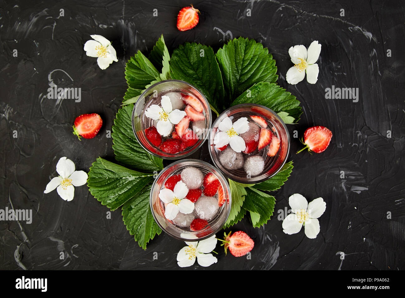 https://c8.alamy.com/comp/P9A062/strawberry-detox-water-with-jasmine-flower-summer-iced-drink-or-tea-lemonade-with-berry-flavored-water-in-glasses-with-fresh-strawberry-copy-space-P9A062.jpg